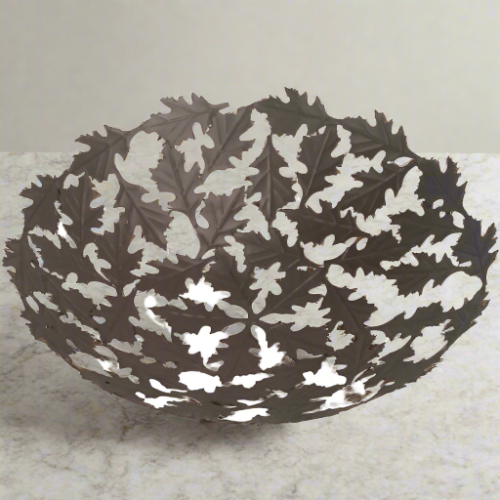 Exquisite Oak Leaf design metal bowl are handmade from recycled bicycle spokes at artist Khalil Ahmed's workshop, one of many fair trade workshops sponsored by Noah's Ark. Measures 11" in diameter.