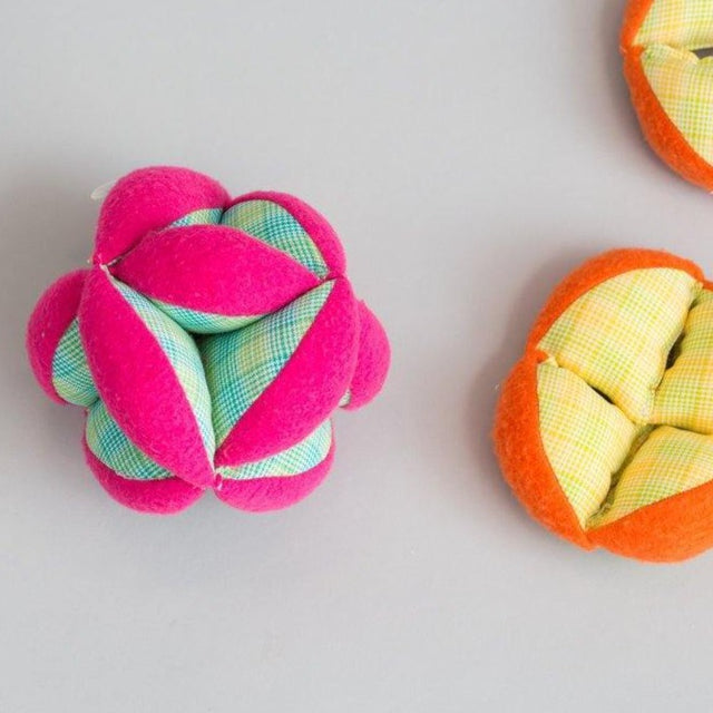 Bright pink and Orange plush soft puzzle balls by Zeki Learning