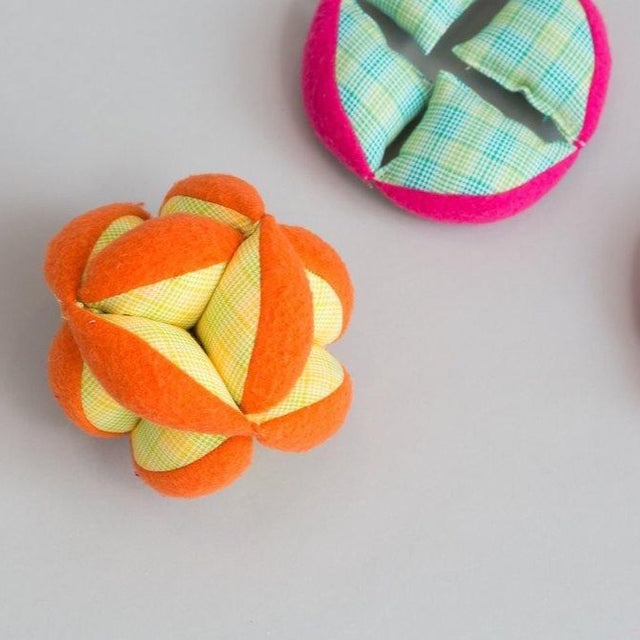 Orange and Yellow plaid soft plush puzzle ball for children by Zeki Learning-Fair Trade Montessori toys and games