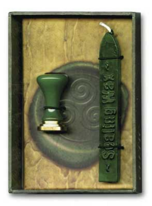 Green sealing wax and stamp with decorative triquetra design in a wooden box