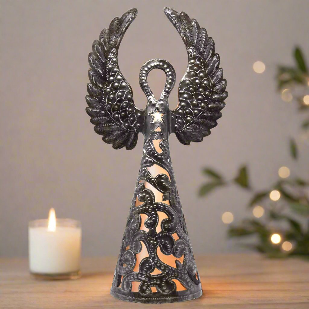 handmade recycled metal Angel luminary with wings up. votive candle shines through it creating a twinkling effect.