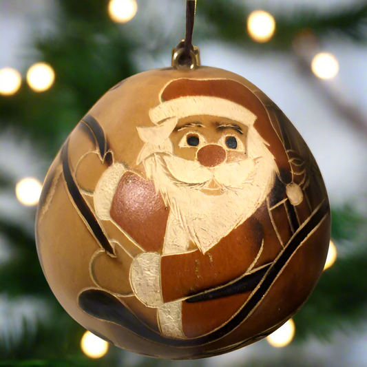 hand-carved gourd ornament with Santa and his reindeer pulled sleigh. Certified Fair Trade product from Low Country Fair Trade