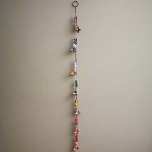 long strand of hanging chakra colored bells and beads.
