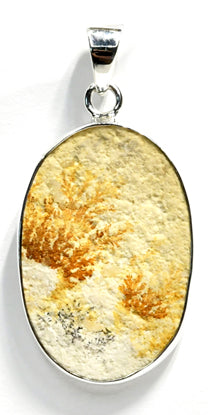 Oval shaped warm yellow, rust, and ivory colored Russian Dendritic Agate pendant wrapped in .925 Sterling Silver
