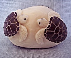 two sea turtles hand carved into Tagua nut or vegetable ivory fair trade imported from Ecuador.