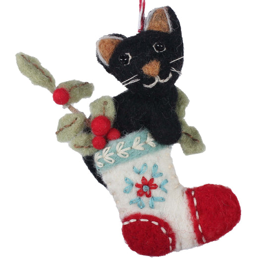 Felt ornament of a black cat on a stocking with holly leaves and berries.