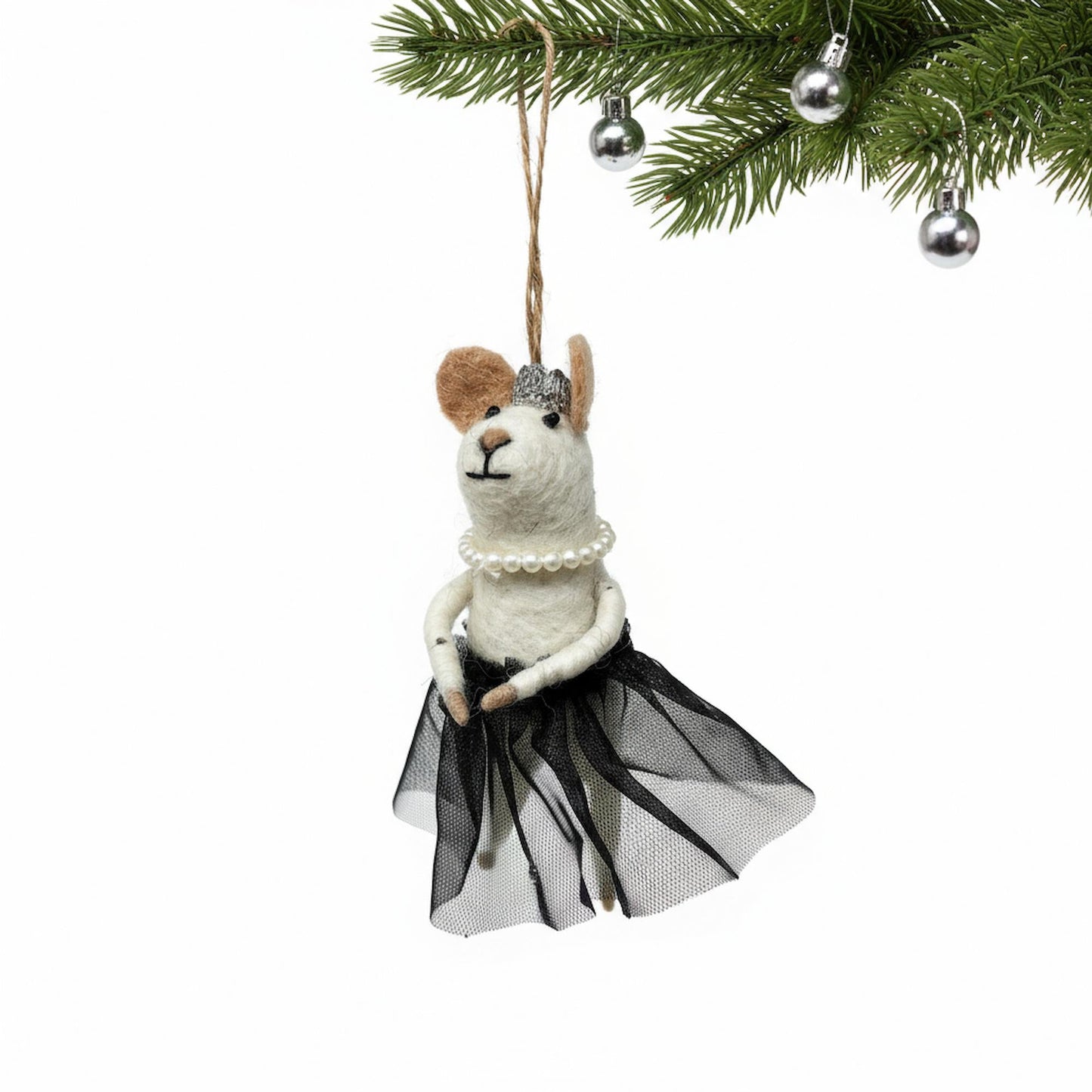 Decorative ornament of a llama in a black tutu and pearl necklace hanging from a Christmas tree.