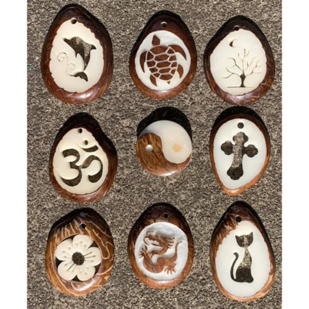 Set of nine oval pendants with various engravings on a textured surface