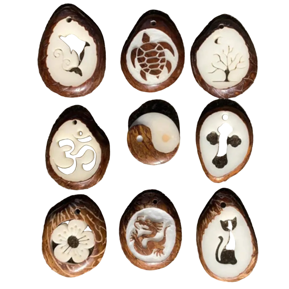 Set of nine tagua slice pendants with various engravings on a white background