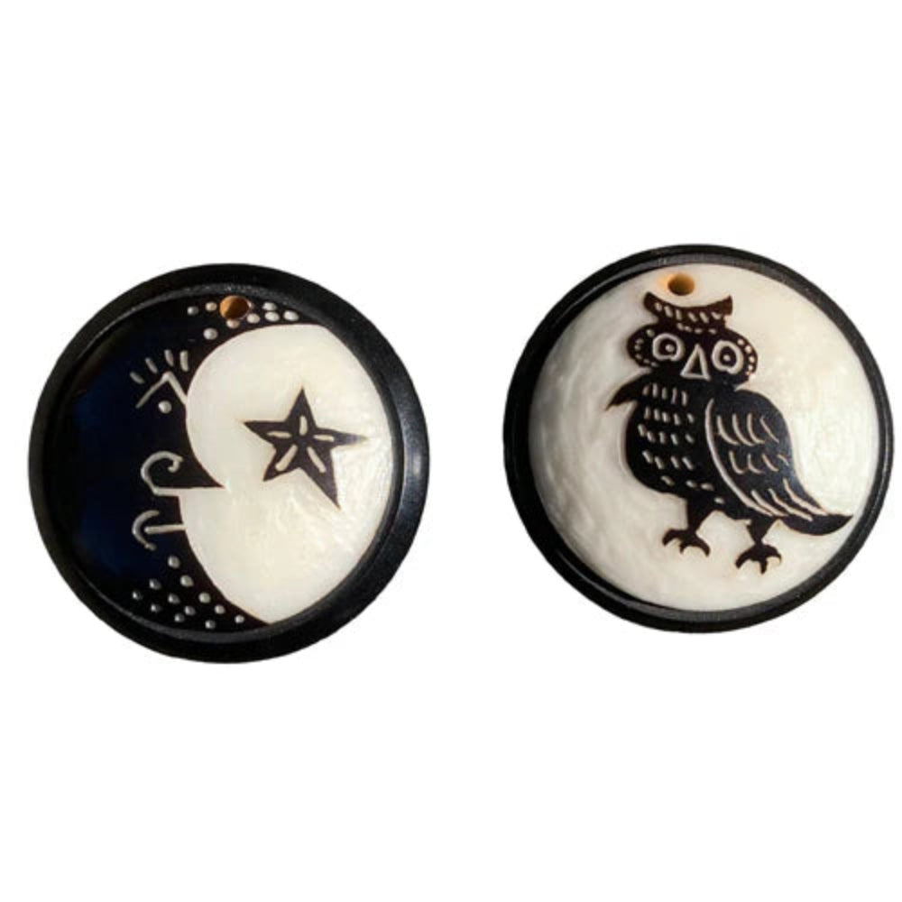 Two circular pendants with star and owl designs on a white background