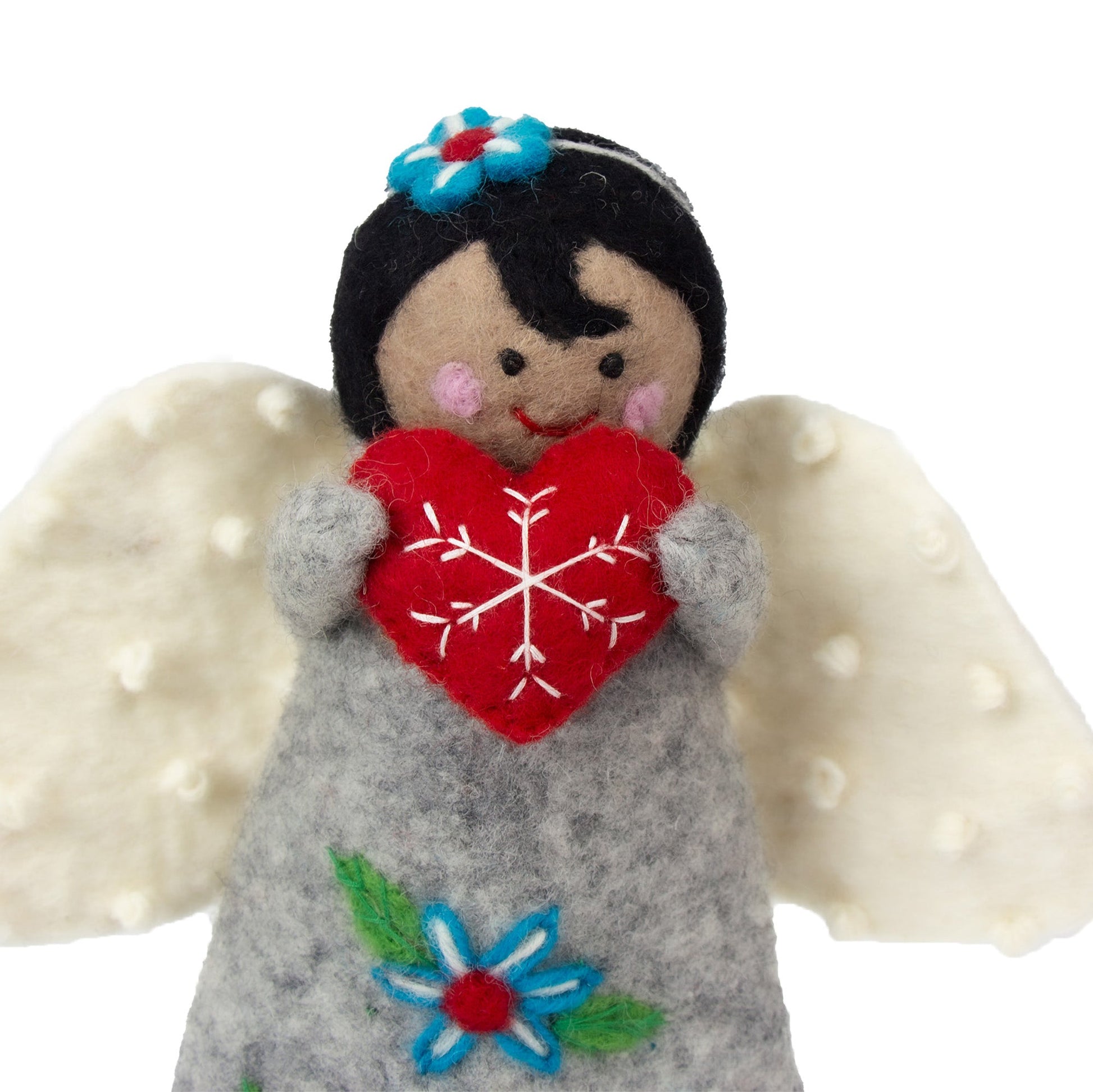 Felt angel Christmas tree topper holding a red heart with a snowflake design, wearing a grey dress with teal flowers on a white background