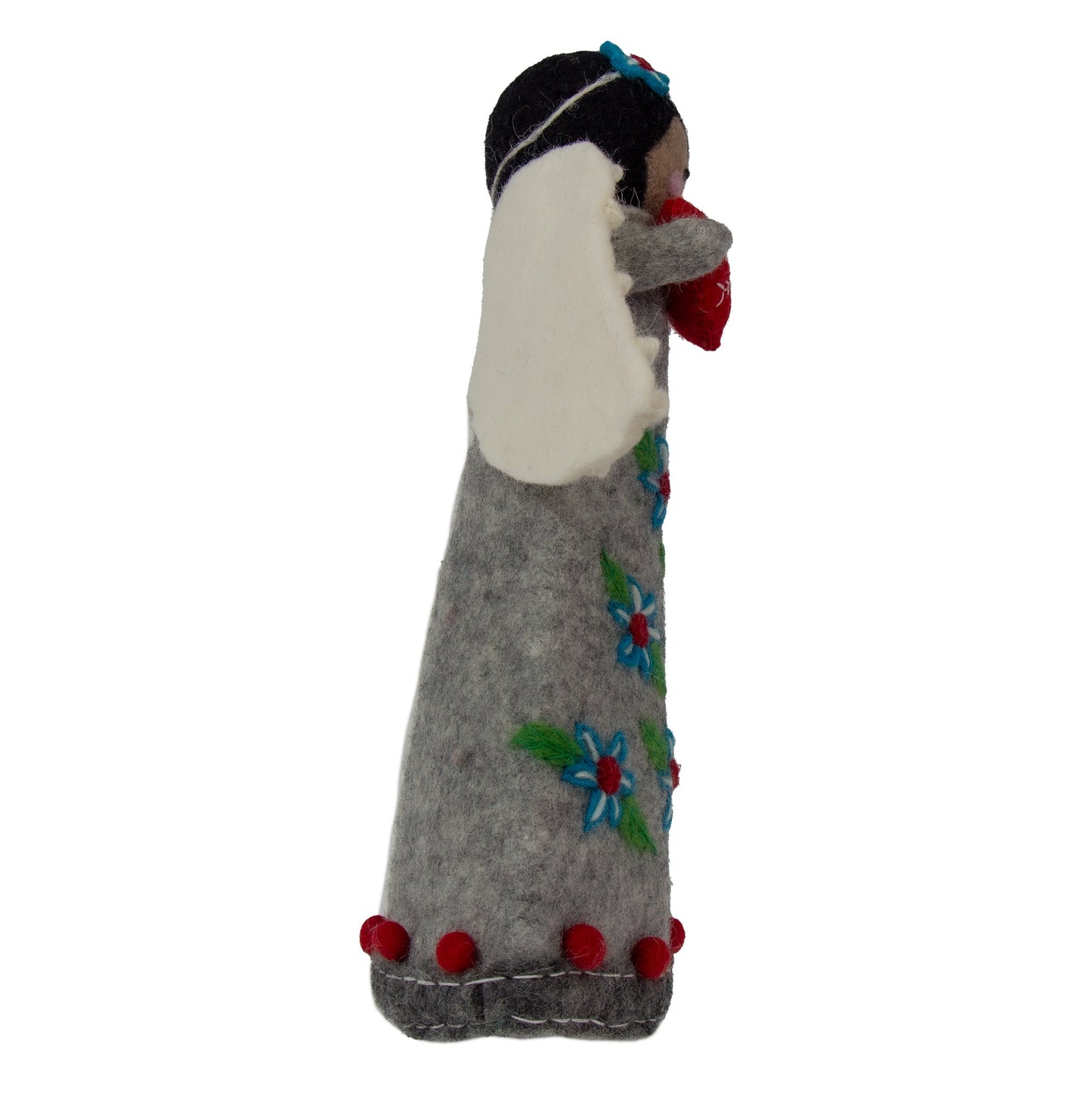Felted doll with floral patterns and red accents on a white background