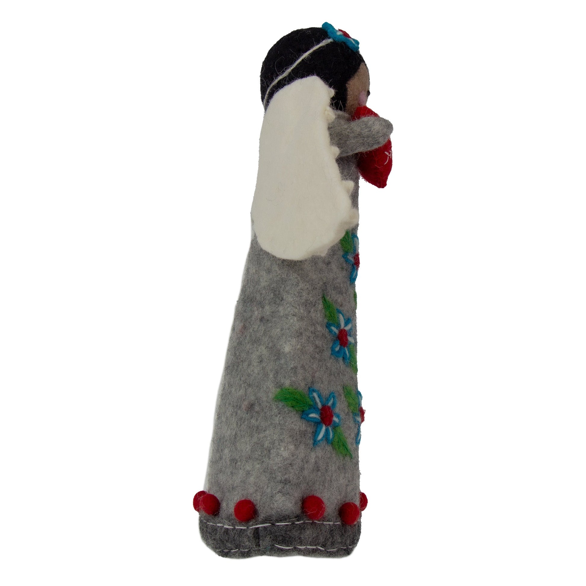 Felted doll with floral patterns and red accents on a white background