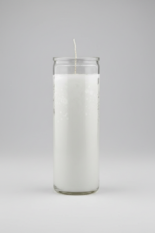 White candle in a glass jar on a gray background