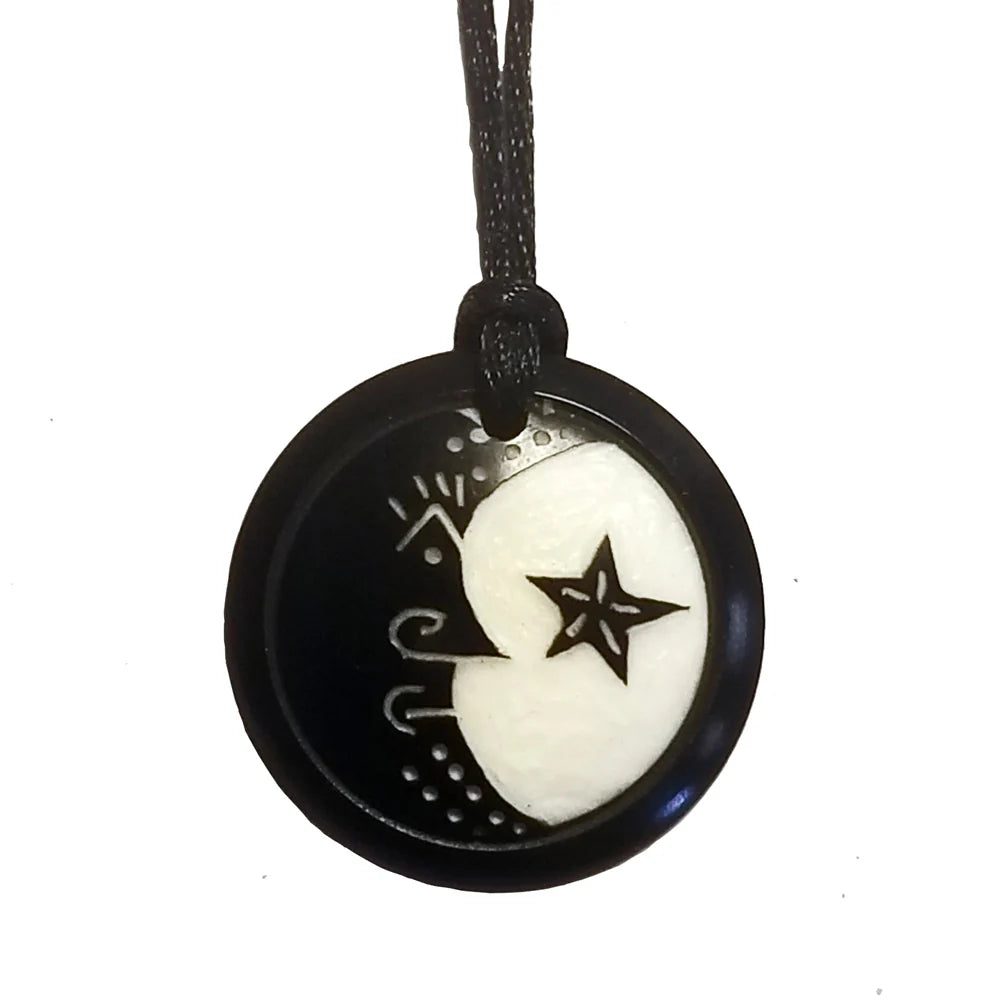 Black and white pendant with star and moon design on a white background