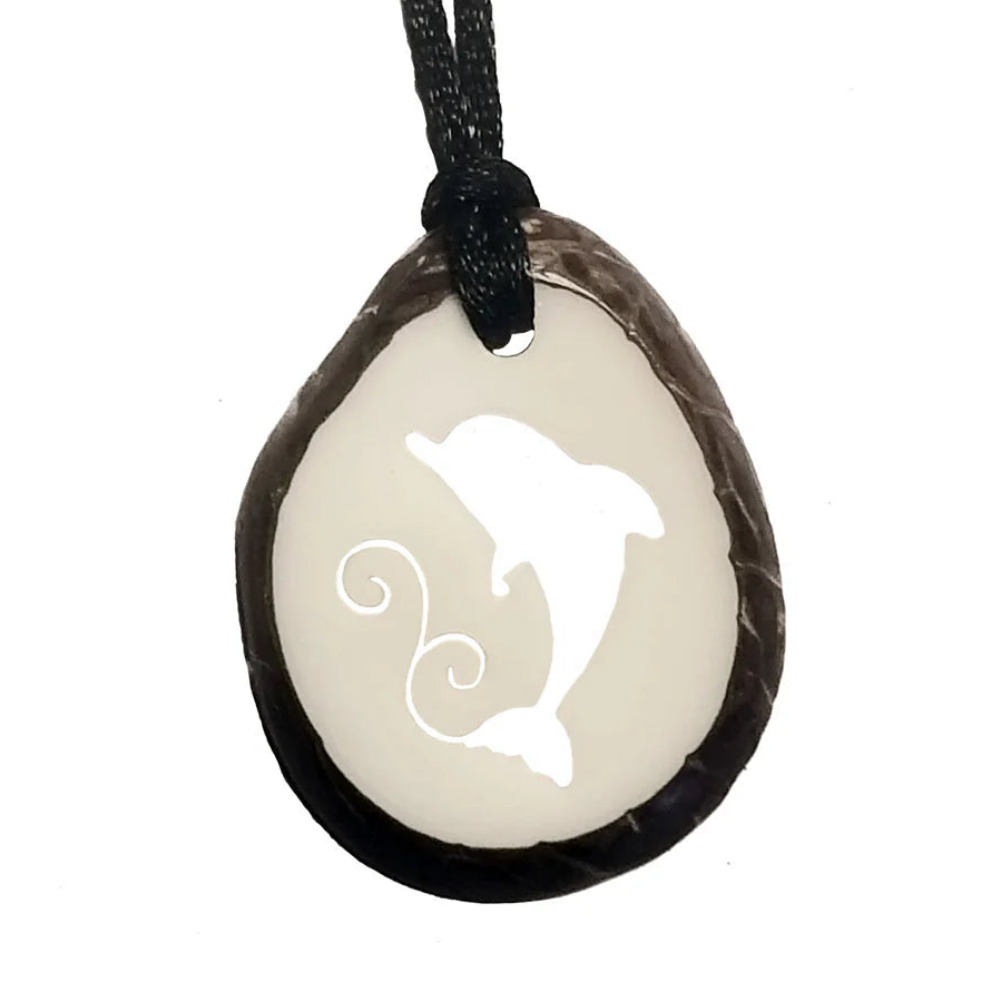 Pendant with dolphin design on a white background