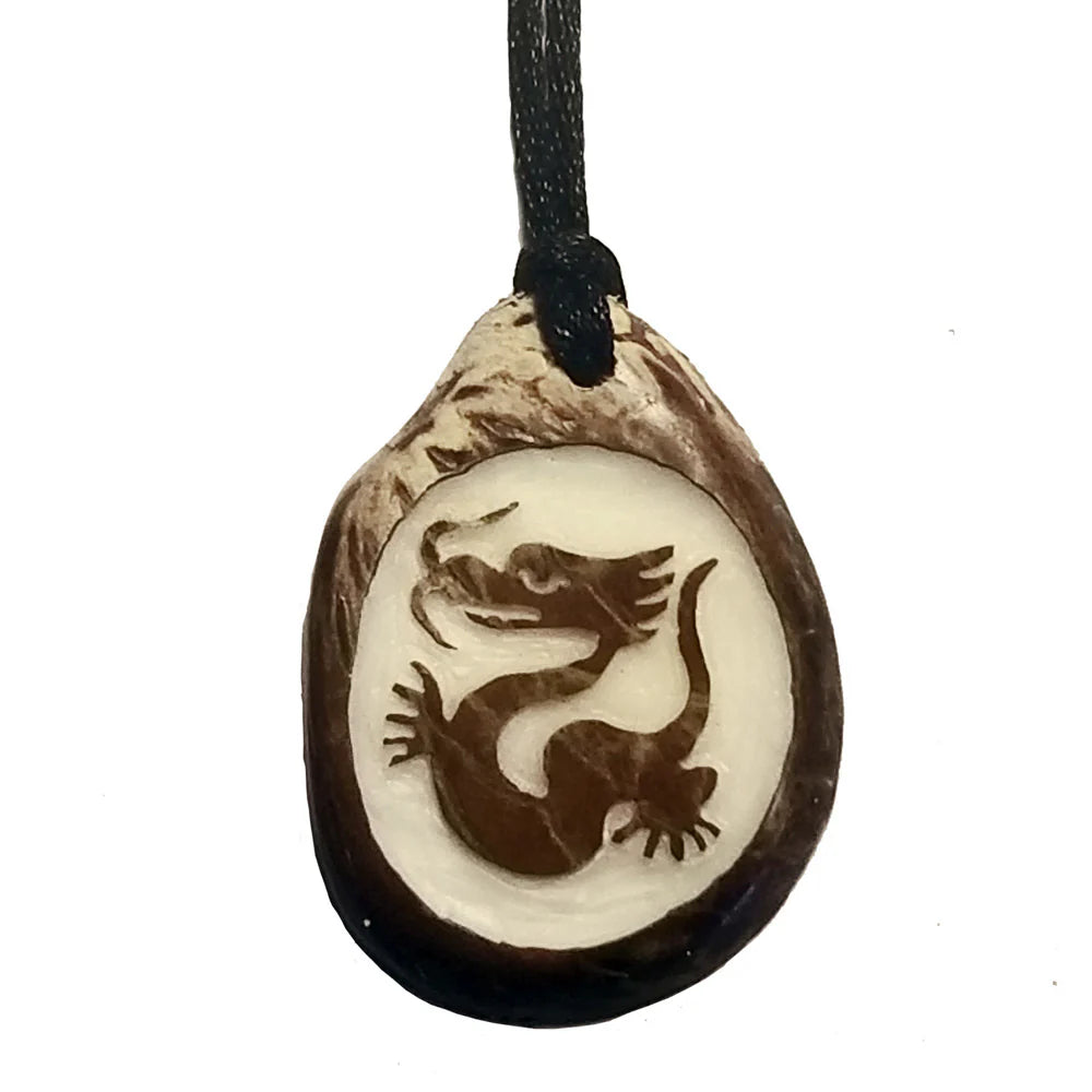 Vegetable Ivory slice Pendant with a hand-carved fire breathing dragon design on a white background