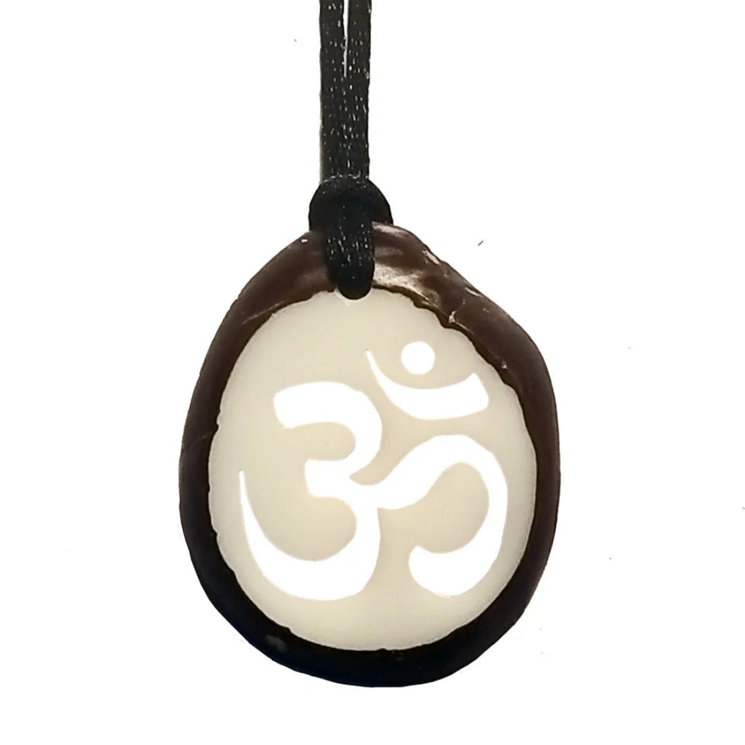 Pendant with Om symbol on a white background