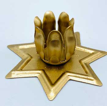 A gold-colored, seven-pointed star-shaped candle holder designed to securely taper candles.