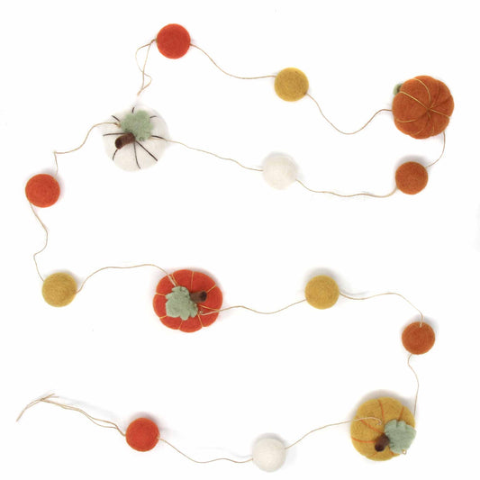Orange, yellow, and white felt pumpkins and felt ball garland for fall and Thanksgiving. 