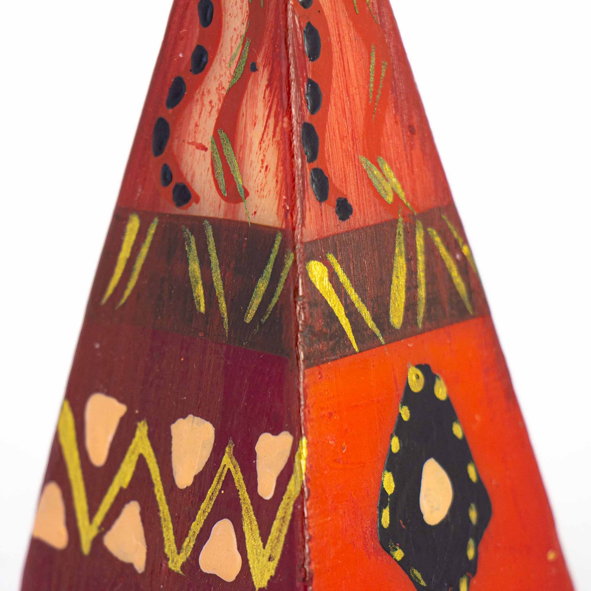 close up of Benghazi design hand-painted on handmade pyramid candle by Nobunto from Low Country Fair Trade.